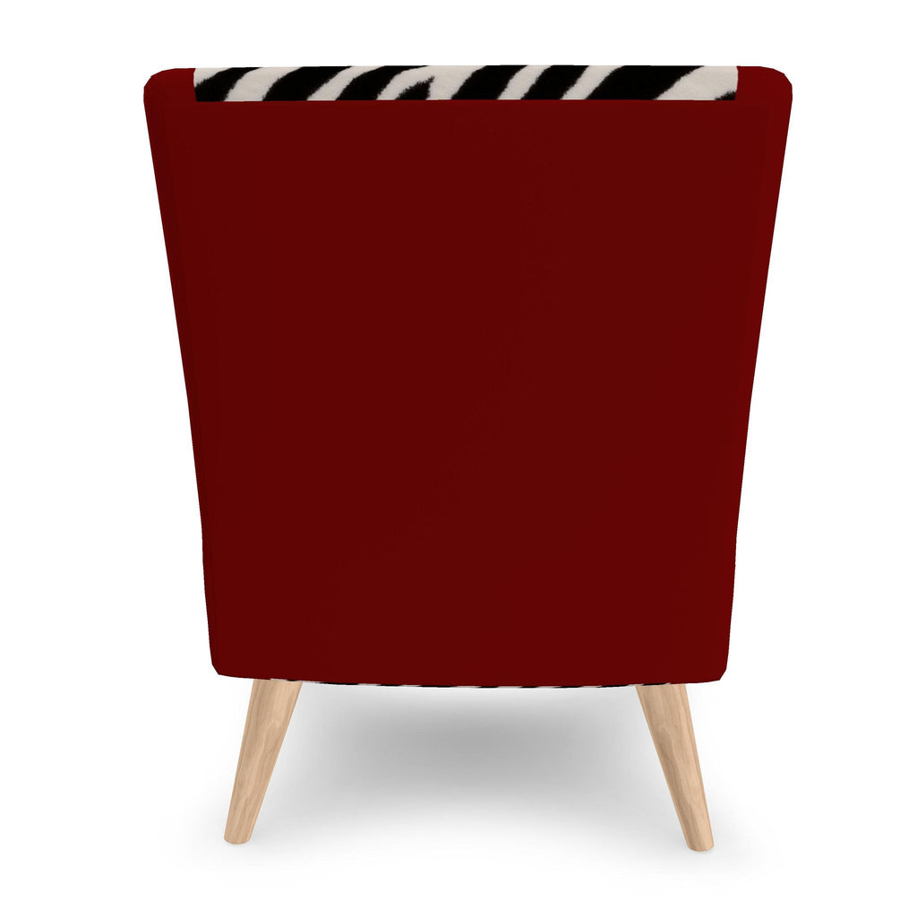 A modern armchair with a deep red upholstered back and seat, light wood legs, and a black and white zebra-patterned accent strip across the top of the backrest, shown against a plain white background.