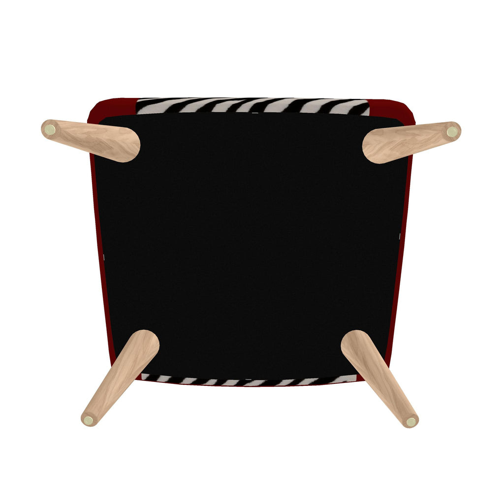 The underside of a modern armchair with a black seat, red side panels, a black and white patterned fabric trim, and four light natural wood legs.
